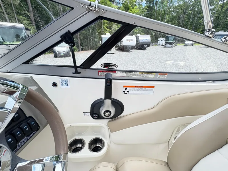 Slide: The Image of Interior view of a 2016 Stingray 188 LX boat, featuring steering wheel and controls. - 16