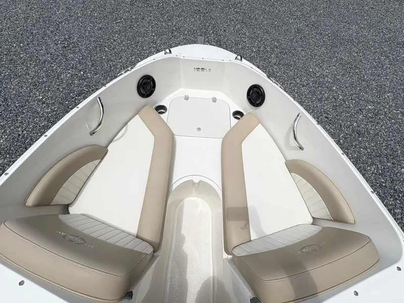 Slide: The Image of 2016 Stingray 188 LX boat interior with beige seating and speakers. - 18