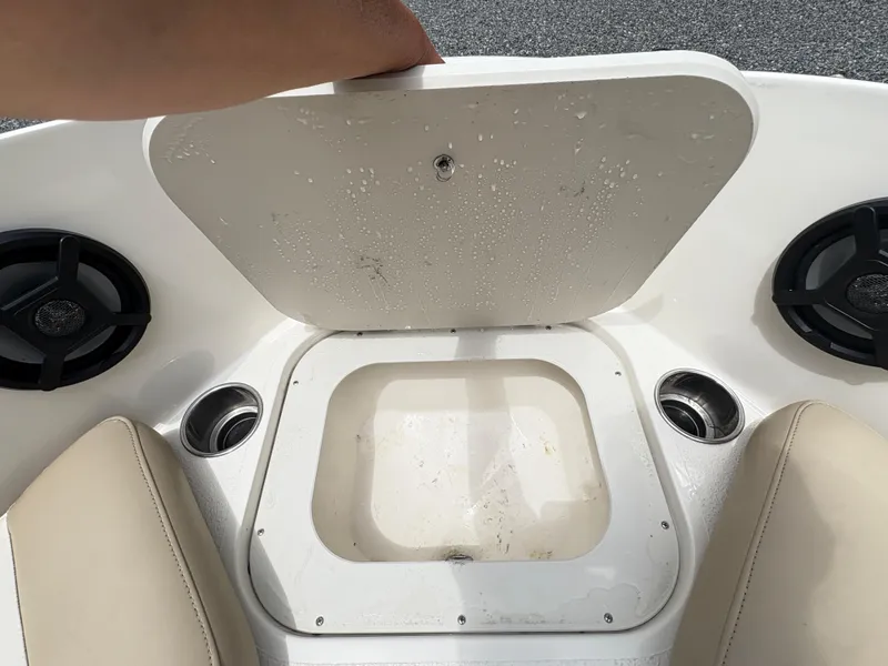 Slide: The Image of 2016 Stingray 188 LX boat storage compartment with cup holders and speakers. - 19