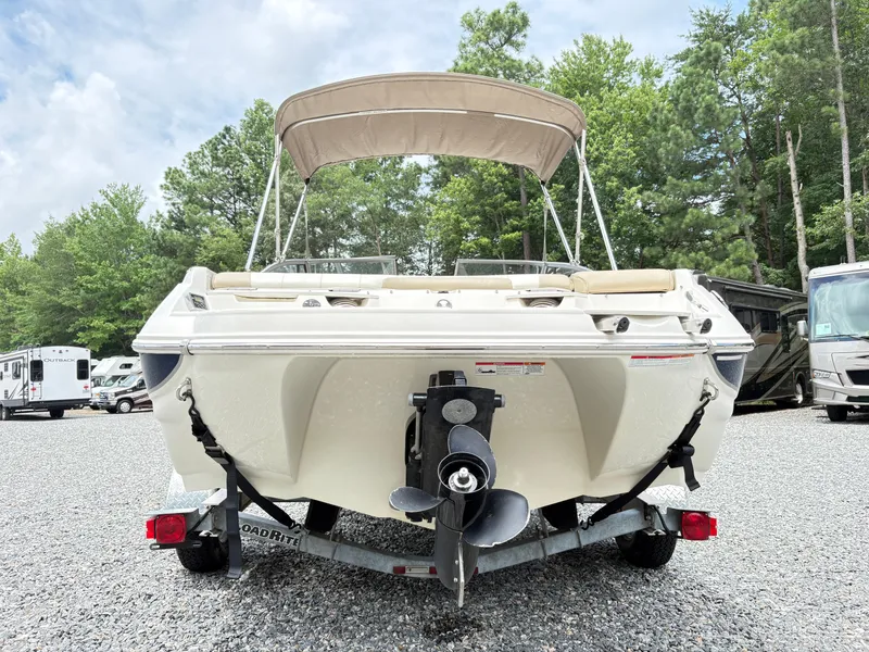 Slide: The Image of 2016 Stingray 188 LX boat on trailer, parked outdoors with trees in background. - 3