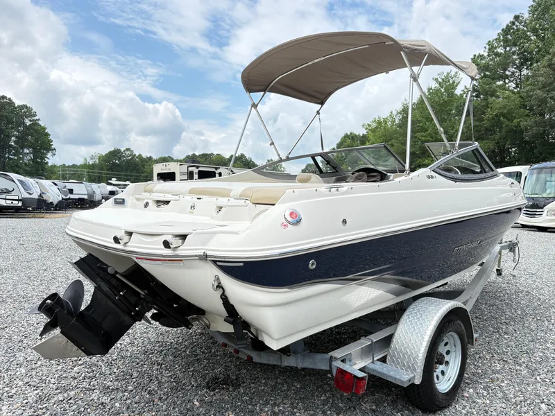 Slide: The Image of 2016 Stingray 188 LX boat on trailer, parked outdoors under cloudy sky. - 4