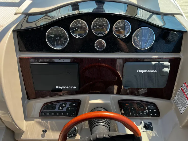 Slide: The Image of Dashboard of 2006 Sea Ray 290 Sundancer with Raymarine navigation system and gauges. - 12