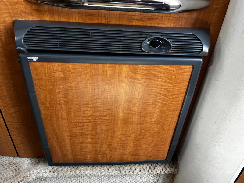 Slide: The Image of Wood-paneled refrigerator in 2006 Sea Ray 290 Sundancer boat interior. - 17