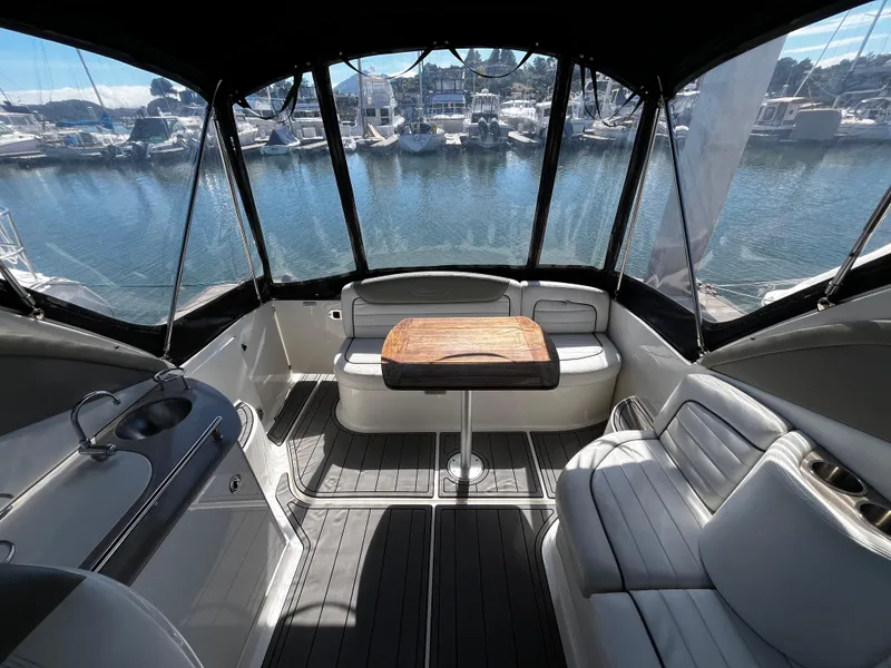 Slide: The Image of Interior of 2006 Sea Ray 290 Sundancer boat with seating and table, docked at marina. - 28