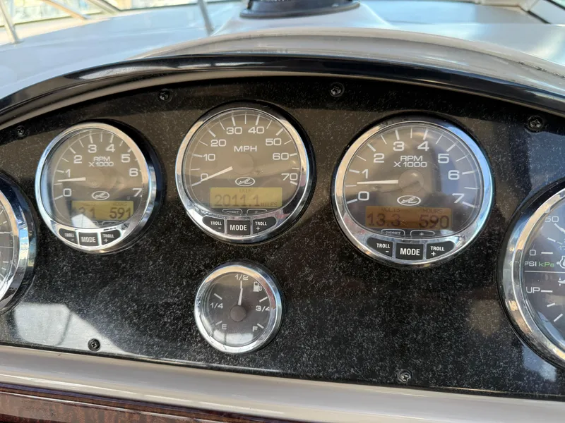 Slide: The Image of Dashboard of a 2006 Sea Ray 290 Sundancer boat with gauges and controls. - 32