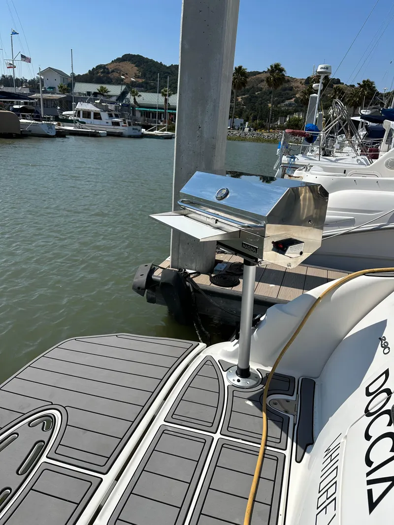Slide: The Image of 2006 Sea Ray 290 Sundancer with mounted grill at marina dock. - 37