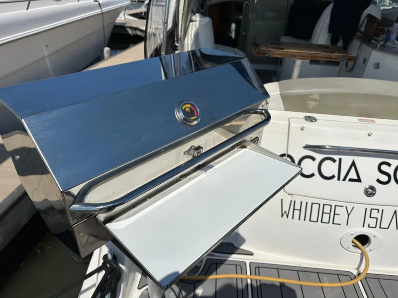 Slide: The Image of 2006 Sea Ray 290 Sundancer with a shiny stainless steel grill on deck. - 38