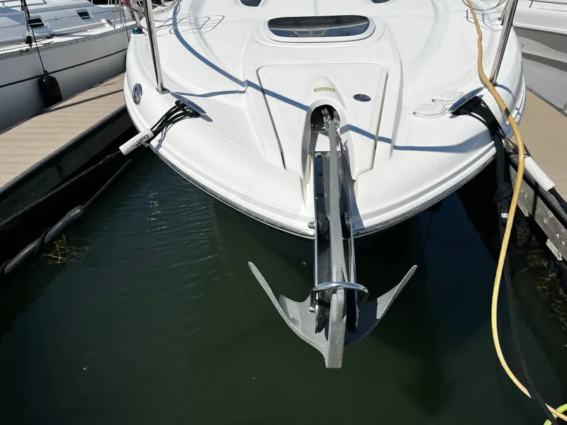 Slide: The Image of 2006 Sea Ray 290 Sundancer boat docked, showing anchor and bow details. - 6