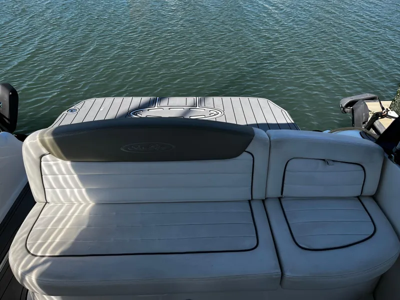 Slide: The Image of 2006 Sea Ray 290 Sundancer boat with white seating and water view. - 9