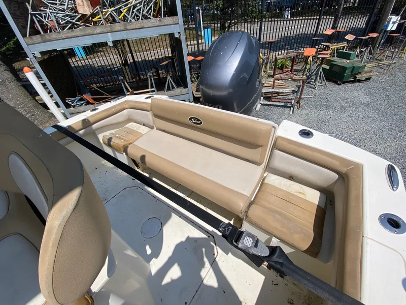 Slide: The Image of 2012 Scout 225 XSF boat interior with seating and engine view. - 12