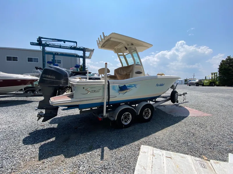 Slide: The Image of 2012 Scout 225 XSF boat on trailer at marina, sunny day. - 2