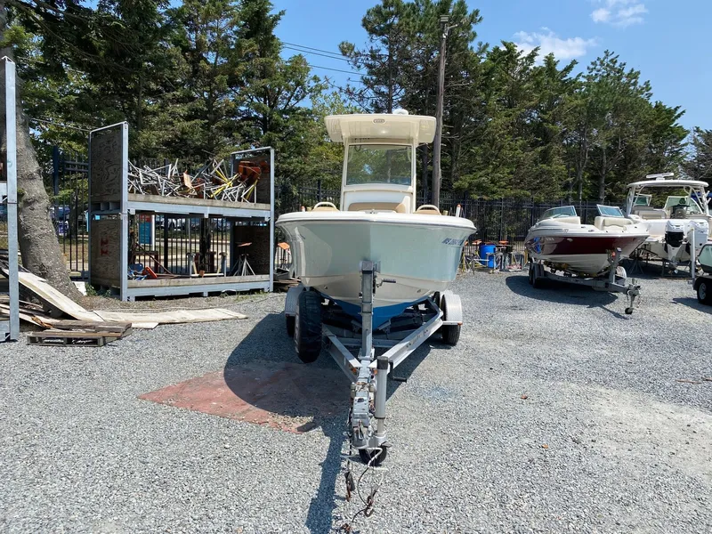 Slide: The Image of 2012 Scout 225 XSF boat on trailer in outdoor storage area. - 3