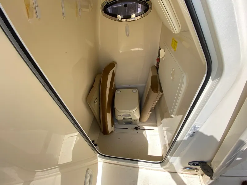 Slide: The Image of 2012 Scout 225 XSF boat interior with compact marine toilet and storage. - 7