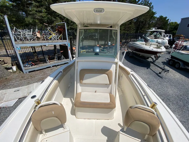 Slide: The Image of 2012 Scout 225 XSF boat interior with seating, parked outdoors. - 9