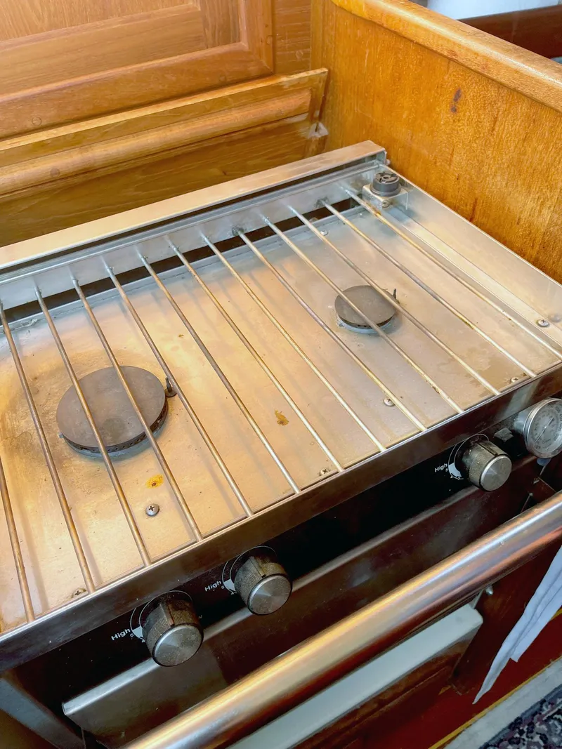 Slide: The Image of Stove inside 1987 Pacific Seacraft Dana 24 sailboat, featuring two burners and control knobs. - 11