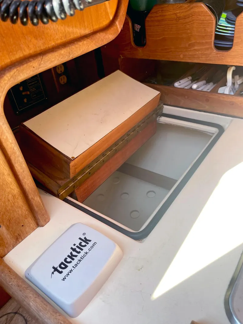 Slide: The Image of Interior of 1987 Pacific Seacraft Dana 24 sailboat with storage compartment and Tacktick device. - 12