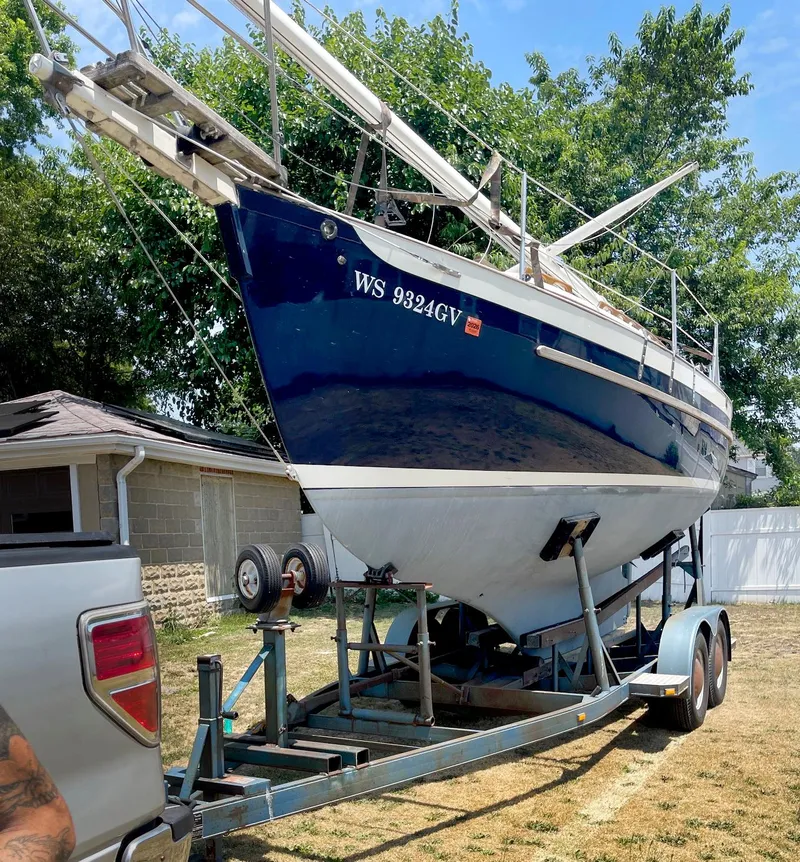 Slide: The Image of 1987 Pacific Seacraft Dana 24 sailboat on trailer, parked outdoors. - 2