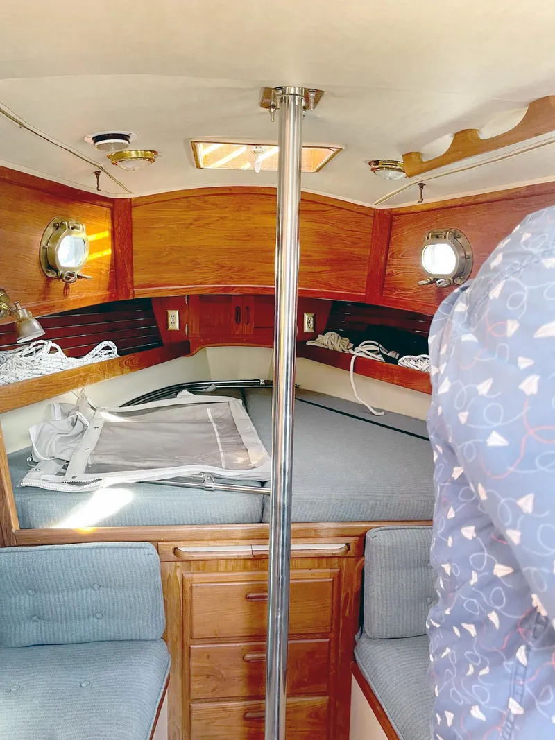 Slide: The Image of Interior of 1987 Pacific Seacraft Dana 24 sailboat with wooden finish and cozy seating. - 4