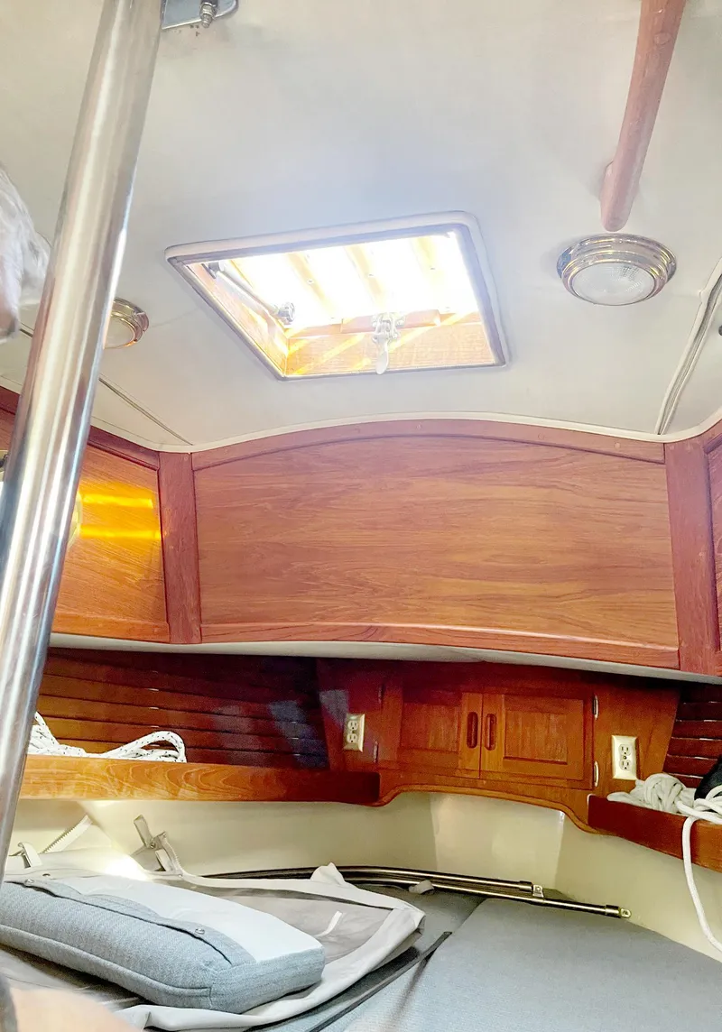 Slide: The Image of Interior of 1987 Pacific Seacraft Dana 24 sailboat with wooden cabinetry and overhead hatch. - 5