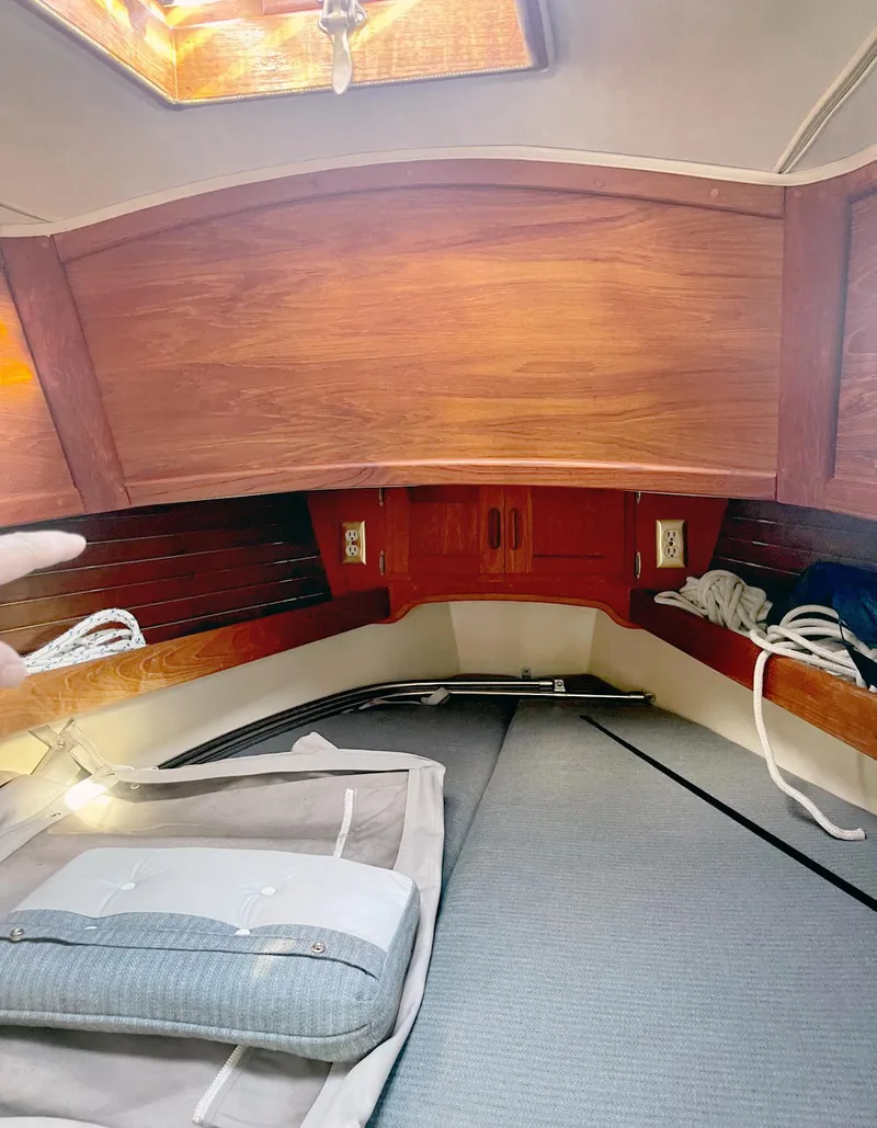 Slide: The Image of Cozy interior of 1987 Pacific Seacraft Dana 24 sailboat with wooden finish and cushions. - 6