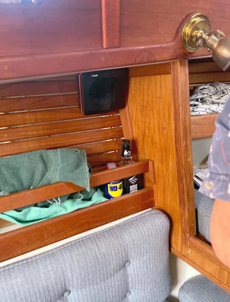 Slide: The Image of Interior of 1987 Pacific Seacraft Dana 24 sailboat with wooden shelves and seating. - 8