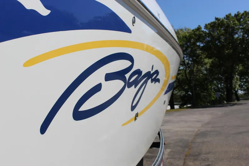 Slide: The Image of 2002 Baja 342 boat with logo, parked on a sunny day. - 11
