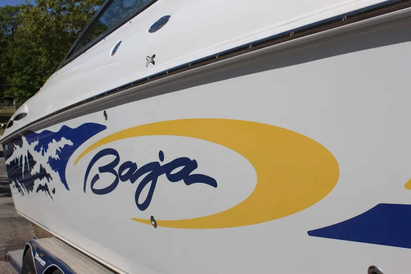 Slide: The Image of 2002 Baja 342 boat with blue and yellow graphics on the side. - 12
