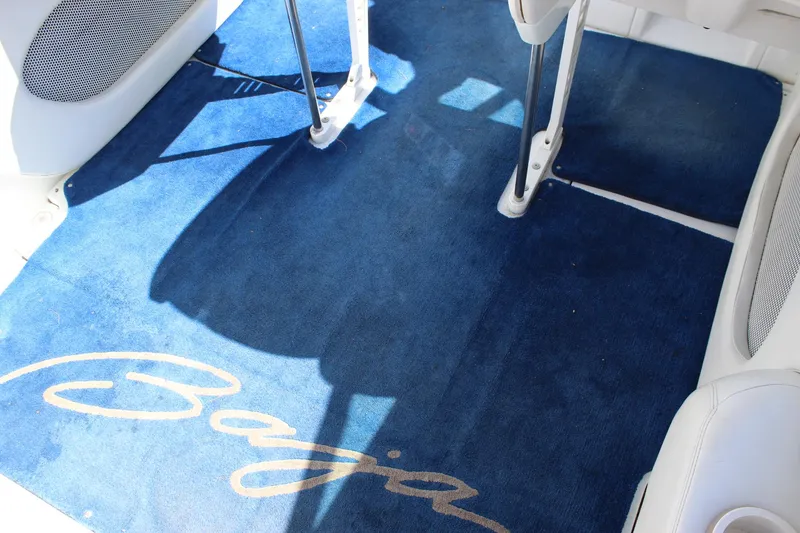Slide: The Image of Blue carpet with "Baja" logo in a 2002 Baja 342 boat interior. - 18
