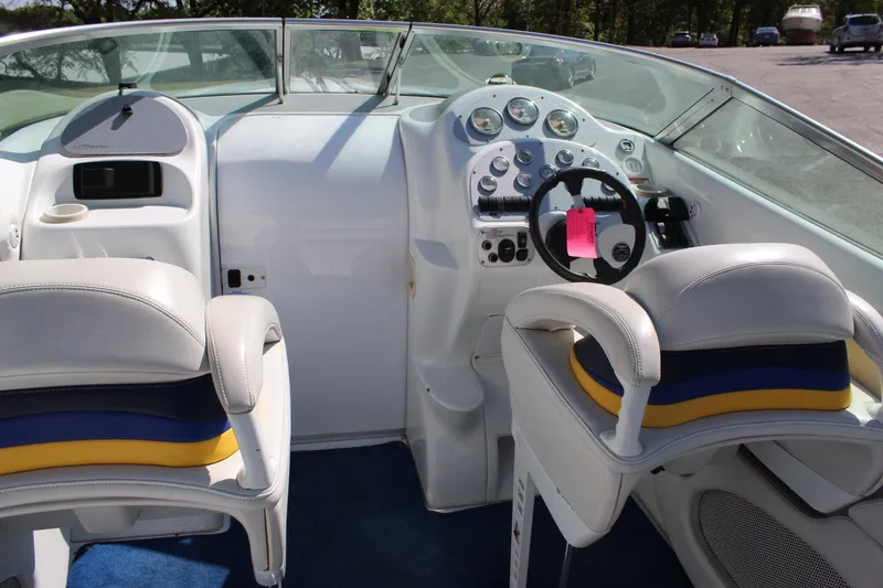 Slide: The Image of Interior of a 2002 Baja 342 boat with dual seats and control panel. - 19