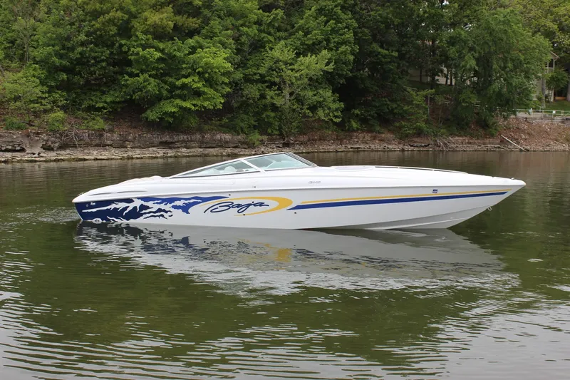 Slide: The Image of 2002 Baja 342 speedboat on calm water, featuring sleek design and vibrant graphics. - 2