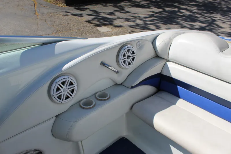 Slide: The Image of Interior of a 2002 Baja 342 boat with white and blue seating, speakers, and cup holders. - 23