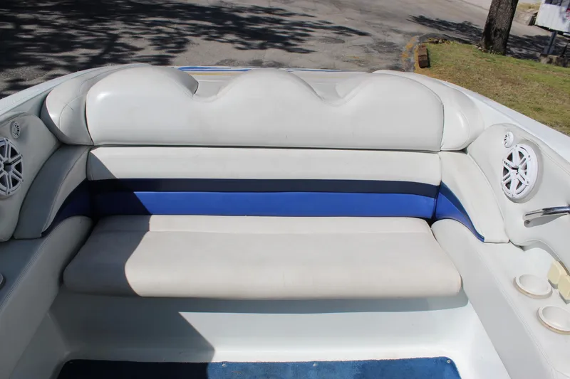 Slide: The Image of 2002 Baja 342 boat interior with white and blue seating, featuring built-in speakers. - 24