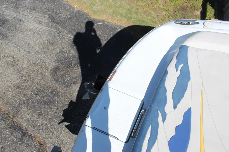 Slide: The Image of 2002 Baja 342 boat with colorful deck design and shadow on pavement. - 25