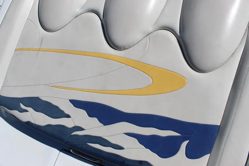 Slide: The Image of 2002 Baja 342 boat seat with abstract blue and yellow design. - 26