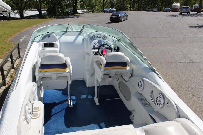 Slide: The Image of 2002 Baja 342 boat interior with white seats, blue carpet, and control panel. - 27