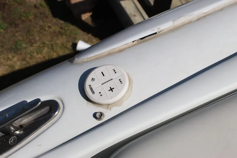Slide: The Image of Control panel on a 2002 Baja 342 boat deck, featuring audio buttons. - 28