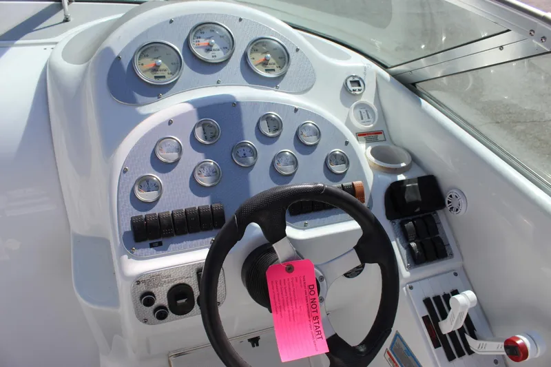 Slide: The Image of 2002 Baja 342 boat dashboard with steering wheel and instrument gauges. - 30