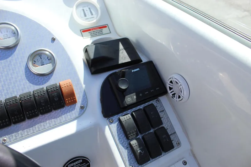 Slide: The Image of Control panel of a 2002 Baja 342 boat with gauges and switches. - 31