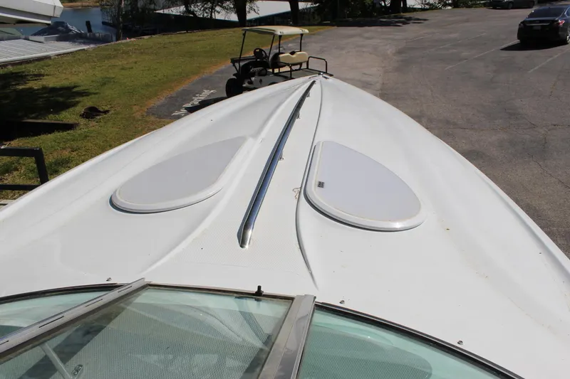 Slide: The Image of 2002 Baja 342 boat deck with sleek design and dual hatches. - 32