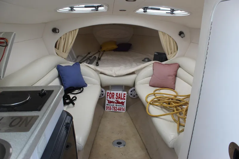 Slide: The Image of 2002 Baja 342 boat interior with seating, bed, and "For Sale" sign. - 33