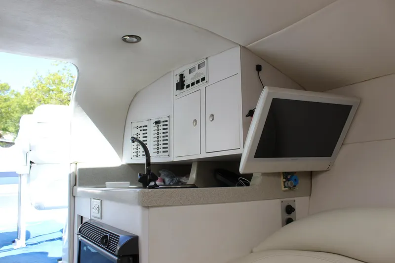 Slide: The Image of Interior of a 2002 Baja 342 boat featuring a control panel and monitor. - 34