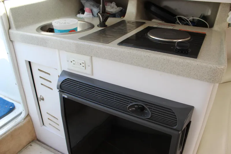 Slide: The Image of 2002 Baja 342 boat kitchenette with stove, sink, and mini-fridge. - 35