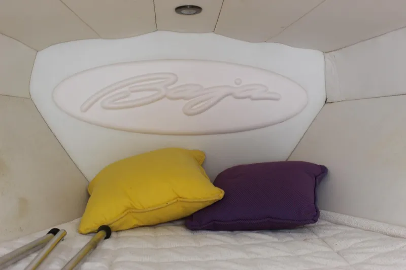Slide: The Image of 2002 Baja 342 boat interior with yellow and purple pillows. - 37