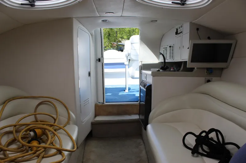 Slide: The Image of Interior of a 2002 Baja 342 boat with seating, TV, and equipment. - 38