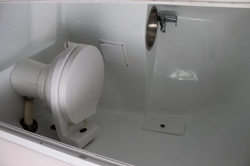 Slide: The Image of 2002 Baja 342 boat bathroom with white marine toilet and sink. - 39
