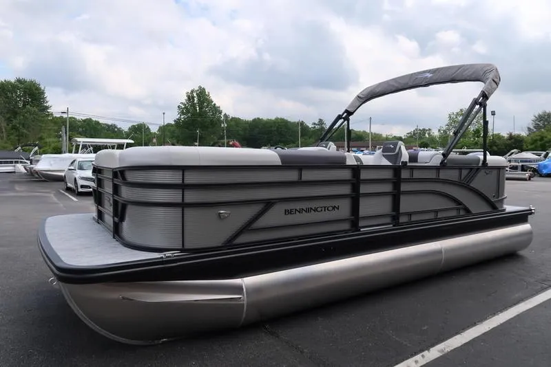 Slide: The Image of 2026 Bennington S Quad Bench 22 SSR pontoon boat in a parking lot. - 10