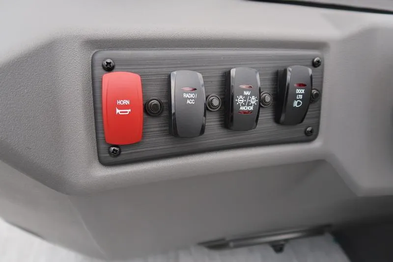 Slide: The Image of Control panel of 2026 Bennington S Quad Bench 22 SSR with horn, radio, navigation, and dock lights switches. - 23