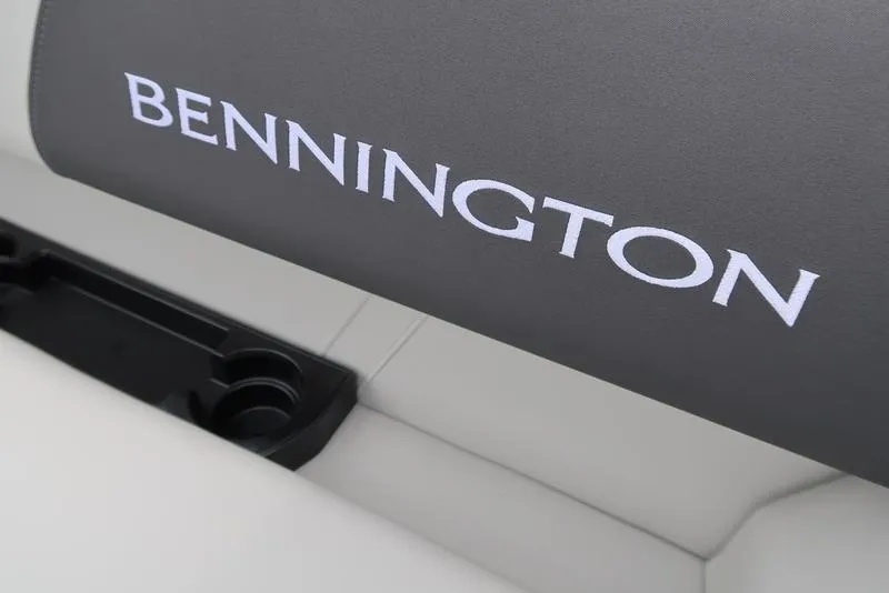 Slide: The Image of Bennington S Quad Bench 22 SSR 2026 boat seat with logo and cup holder. - 24
