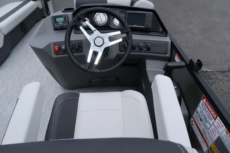 Slide: The Image of 2026 Bennington S Quad Bench 22 SSR boat dashboard with steering wheel and controls. - 25