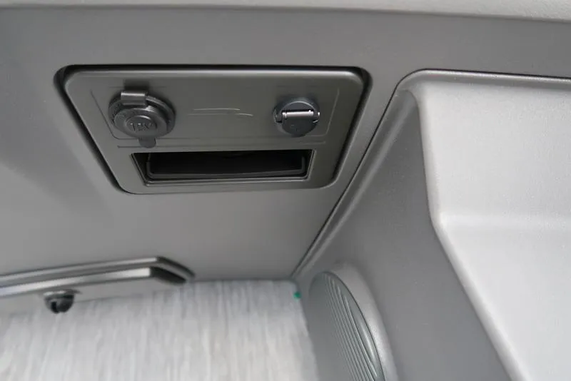 Slide: The Image of 2026 Bennington S Quad Bench 22 SSR interior detail with power outlet and speaker. - 27